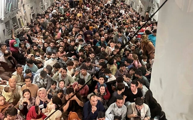 Afghan citizens pack inside a US Air Force C-17 Globemaster III, as they are transported from Hamid Karzai International Airport in Afghanistan, on Sunday, August 15, 2021 (Capt. Chris Herbert/US Air Force via AP)