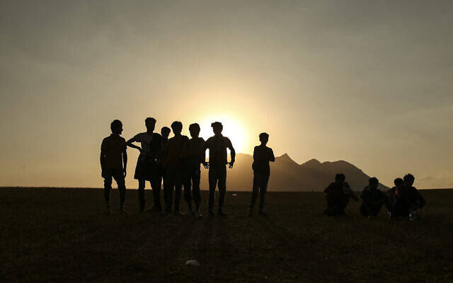 Young men who say they deserted the Afghan military and fled to Turkey through Iran stand in the countryside in Tatvan, in Bitlis Province in eastern Turkey, Tuesday, Aug. 17, 2021. (AP Photo/Emrah Gurel) Young men who say they deserted the Afghan military and fled to Turkey through Iran stand in the countryside in Tatvan, in Bitlis Province in eastern Turkey, Tuesday, Aug. 17, 2021. (AP Photo/Emrah Gurel)
