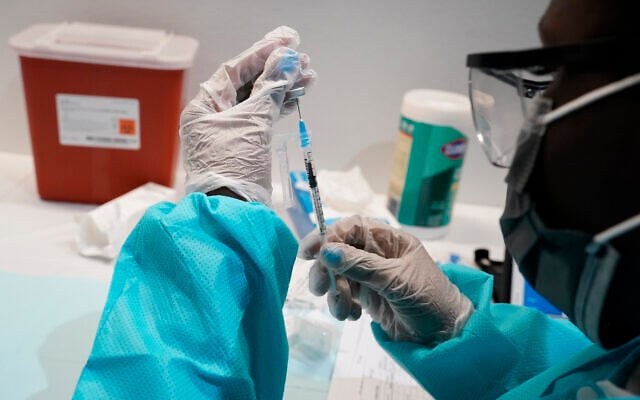 A healthcare worker fills a syringe with the Pfizer COVID-19 vaccine at the American Museum of Natural History in New York, July 22, 2021. (AP Photo/Mary Altaffer, File) A healthcare worker fills a syringe with the Pfizer COVID-19 vaccine at the American Museum of Natural History in New York, July 22, 2021. (AP Photo/Mary Altaffer, File)