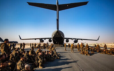 Marines assigned to the 24th Marine Expeditionary Unit (MEU) await a flight to Kabul Afghanistan, at Al Udeied Air Base, Qatar Tuesday, Aug. 17, 2021 (1st Lt. Mark Andries/U.S. Marine Corps via AP)