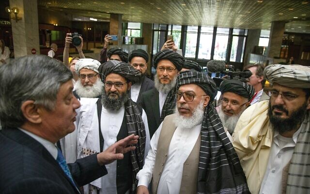 In this Tuesday, May 28, 2019 file photo, Russian presidential envoy to Afghanistan Zamir Kabulov, left, speaks to Mullah Abdul Ghani Baradar, the Taliban group's top political leader, third left, Sher Mohammad Abbas Stanikzai, the Taliban's chief negotiator, third right, and other members of the Taliban delegation prior to their talks in Moscow, Russia. (AP Photo/Alexander Zemlianichenko, File) In this Tuesday, May 28, 2019 file photo, Russian presidential envoy to Afghanistan Zamir Kabulov, left, speaks to Mullah Abdul Ghani Baradar, the Taliban group's top political leader, third left, Sher Mohammad Abbas Stanikzai, the Taliban's chief negotiator, third right, and other members of the Taliban delegation prior to their talks in Moscow, Russia. (AP Photo/Alexander Zemlianichenko, File)