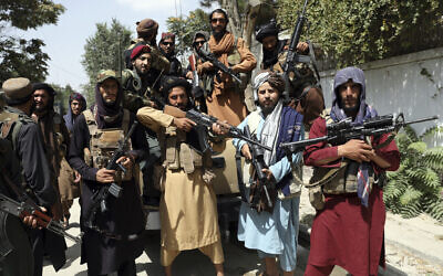 Taliban fighters pose for a photograph in Kabul, Afghanistan, on Thursday, August 19, 2021. (AP Photo/Rahmat Gul)