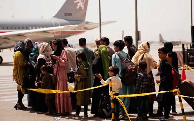 In this photo provided by the US Marine Corps, civilians prepare to board a plane during an evacuation at Hamid Karzai International Airport, Kabul, Afghanistan, on August 18, 2021. (Staff Sgt. Victor Mancilla/US Marine Corps via AP) In this photo provided by the US Marine Corps, civilians prepare to board a plane during an evacuation at Hamid Karzai International Airport, Kabul, Afghanistan, on August 18, 2021. (Staff Sgt. Victor Mancilla/US Marine Corps via AP)