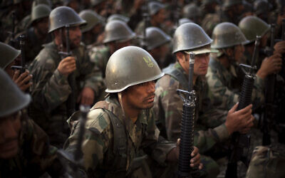 Afghan National Army recruits listen to the explanations of their instructor during a training session at the Kabul Military Training Center in Afghanistan, July 19, 2009. (AP Photo/Emilio Morenatti)