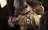 US Army flight medic SGT Jaime Adame, top, cares for seriously wounded Marine CPL Andrew Smith following an insurgent attack on board a medevac helicopter, May 15, 2011, from the US Army's Task Force Lift "Dust Off", Charlie Company 1-214 Aviation Regiment north of Sangin, in the volatile Helmand Province of southern Afghanistan. (AP Photo/Kevin Frayer)
