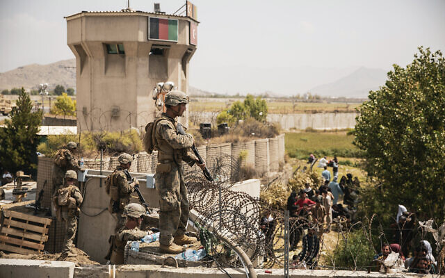 In this image provided by the US Marine Corps, Marines assist with security at an evacuation control checkpoint during an evacuation at Hamid Karzai International Airport in Kabul, Afghanistan, on August 20, 2021. (Staff Sgt. Victor Mancilla/US Marine Corps via AP) In this image provided by the US Marine Corps, Marines assist with security at an evacuation control checkpoint during an evacuation at Hamid Karzai International Airport in Kabul, Afghanistan, on August 20, 2021. (Staff Sgt. Victor Mancilla/US Marine Corps via AP)