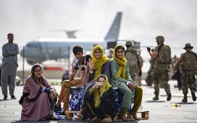 In this image provided by the US Marines, evacuee children wait for the next flight after being manifested at Hamid Karzai International Airport, in Kabul, Afghanistan, on Thursday, August 19, 2021. (1st Lt. Mark Andries/U.S. Marine Corps via AP)
