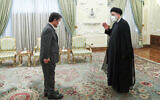 Iranian President Ebrahim Raisi, right, welcomes Japanese Foreign Minister Toshimitsu Motegi for their meeting at the presidency office, in Tehran, Iran, on August 22, 2021. (Iranian Presidency Office via AP)