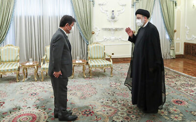 Iranian President Ebrahim Raisi, right, welcomes Japanese Foreign Minister Toshimitsu Motegi for their meeting at the presidency office, in Tehran, Iran, on August 22, 2021. (Iranian Presidency Office via AP)