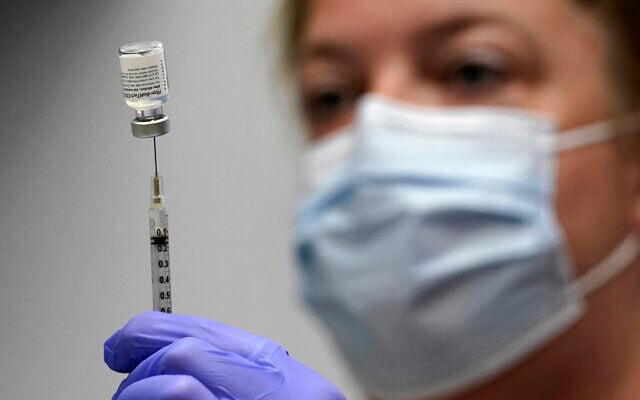 In this March 2, 2021, file photo, pharmacy technician Hollie Maloney loads a syringe with Pfizer's COVID-19 vaccine at the Portland Expo in Portland, Maine. (AP/Robert F. Bukaty, File) In this March 2, 2021, file photo, pharmacy technician Hollie Maloney loads a syringe with Pfizer's COVID-19 vaccine at the Portland Expo in Portland, Maine. (AP/Robert F. Bukaty, File)