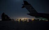 In this image provided by the US Air Force, US Air Force aircrew, assigned to the 816th Expeditionary Airlift Squadron, prepare to load qualified evacuees aboard a US Air Force C-17 Globemaster III aircraft in support of the Afghanistan evacuation at Hamid Karzai International Airport, Kabul, Afghanistan, August 21, 2021. (Senior Airman Taylor Crul/U.S. Air Force via AP)