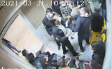 In this undated frame grab taken from video shared with The Associated Press by a self-identified hacker group called "The Justice of Ali," a guard beats a prisoner, at Evin prison in Tehran, Iran. (The Justice of Ali via AP)
