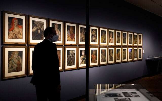 A women takes a photo of the artwork 'Demons of the Hour' by artist Werner Peiner at the exhibition 'Divinely Gifted List' at the German Historic Museum in Berlin, Germany, on August 25, 2021. (AP Photo/Markus Schreiber) A women takes a photo of the artwork 'Demons of the Hour' by artist Werner Peiner at the exhibition 'Divinely Gifted List' at the German Historic Museum in Berlin, Germany, on August 25, 2021. (AP Photo/Markus Schreiber)