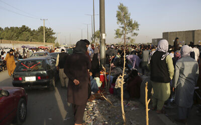 Hundreds of people gather near an evacuation control checkpoint during ongoing evacuations at Hamid Karzai International Airport, in Kabul, Afghanistan, August 25, 2021.  (AP Photo)
