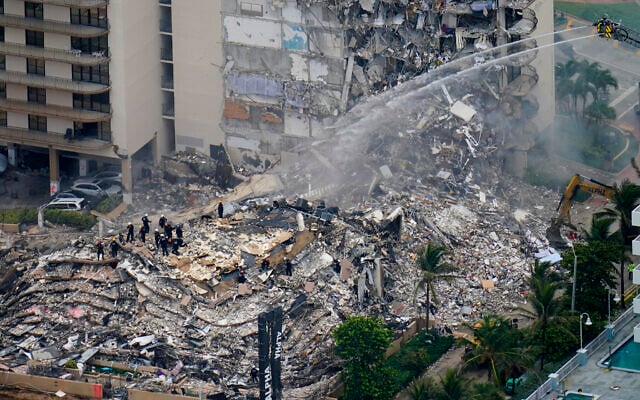 Rescue workers work in the rubble at the Champlain Towers South Condo in Surfside, Florida, June 25, 2021. (AP Photo/Gerald Herbert, File) Rescue workers work in the rubble at the Champlain Towers South Condo in Surfside, Florida, June 25, 2021. (AP Photo/Gerald Herbert, File)
