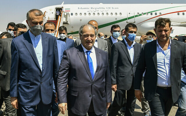 In this photo released by the Syrian official news agency SANA, Syria's Foreign Minister Faisal Mekdad, center left, receives Iran's new Foreign Minister Hossein Amir-Abdollahian, left, in Damascus, Syria, August 29, 2021. (SANA via AP) In this photo released by the Syrian official news agency SANA, Syria's Foreign Minister Faisal Mekdad, center left, receives Iran's new Foreign Minister Hossein Amir-Abdollahian, left, in Damascus, Syria, August 29, 2021. (SANA via AP)