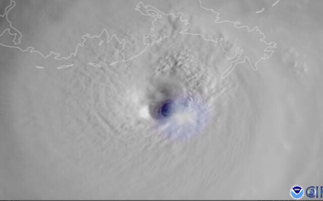 This satellite image provided by the National Oceanic and Atmospheric Administration and captured by NOAA's GOES-16 shows lightning swirling around the eye of Hurricane Ida as the storm approaches the Louisiana coast, Sunday morning, Aug. 29, 2021. (NOAA via AP)