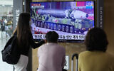 People watch a TV screen showing a file image of a North Korean missile in a military parade during a news program at the Seoul Railway Station in Seoul, South Korea, Monday, August 30, 2021. (AP Photo/Ahn Young-joon)