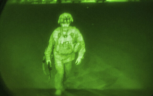 In this image made through a night vision scope, Maj. Gen. Chris Donahue, commander of the US Army 82nd Airborne Division, XVIII Airborne Corps, boards a C-17 cargo plane at Hamid Karzai International Airport in Kabul, Afghanistan, August 30, 2021, as the final American service member to depart Afghanistan. (US Central Command via AP) In this image made through a night vision scope, Maj. Gen. Chris Donahue, commander of the US Army 82nd Airborne Division, XVIII Airborne Corps, boards a C-17 cargo plane at Hamid Karzai International Airport in Kabul, Afghanistan, August 30, 2021, as the final American service member to depart Afghanistan. (US Central Command via AP)
