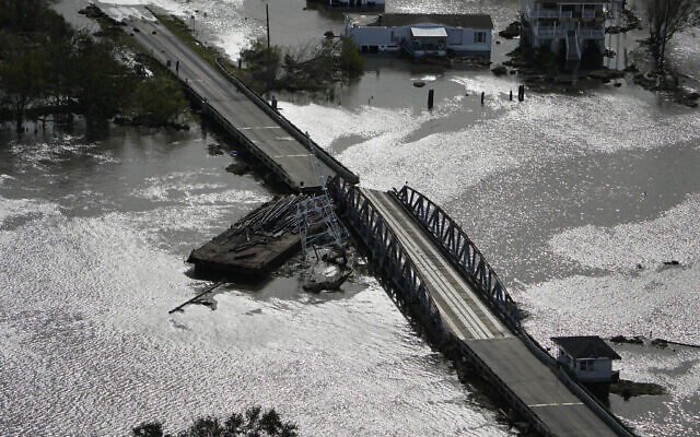 A barge damages a bridge that divides Lafitte and Jean Lafitte, in the aftermath of Hurricane Ida, August 30, 2021, in Louisiana. (AP Photo/David J. Phillip)
