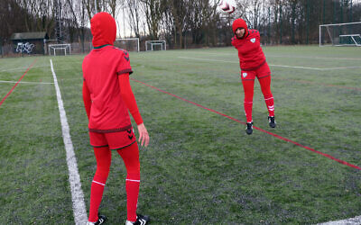 Illustrative: Afghani national soccer team player Shabnam Mabarz, seen from behind, watches as Khalida Popal, the former Afghanistan national women's team captain, heads the ball in Copenhagen on March 8, 2016. (AP Photos/Jan M. Olsen)