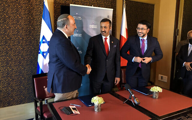 Bahrain's Undersecretary for International Relations Sheikh Abdullah bin Ahmad al Khalifa (c) shakes hands with JCPA President Dore Gold (l) at the King David Hotel in Jerusalem, August 8, 2021 (Lazar Berman/Times of Israel) Bahrain's Undersecretary for International Relations Sheikh Abdullah bin Ahmad al Khalifa (c) shakes hands with JCPA President Dore Gold (l) at the King David Hotel in Jerusalem, August 8, 2021 (Lazar Berman/Times of Israel)