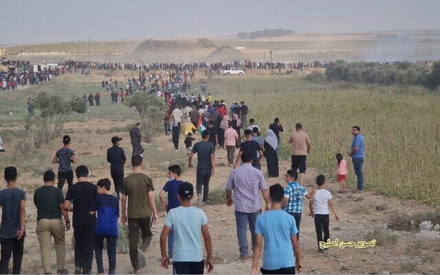Gazans march towards border fence with Israel during a protest, on Saturday, August 21, 2021. (Credit: Hassan Islayeh)