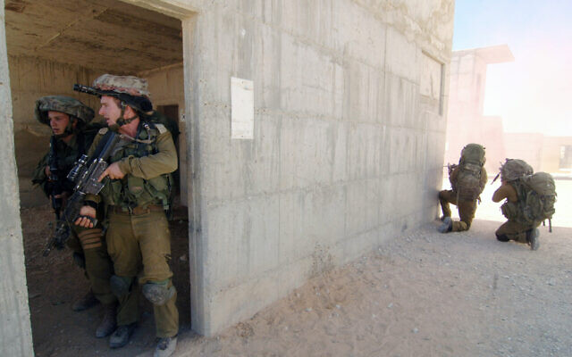 Illustrative: Israeli soldiers from the Paratroopers Brigade take part in a training exercise where they practice door-to-door combat in inhabited areas in Tze'elim, southern Israel, July 10, 2014. (Flash90) Illustrative: Israeli soldiers from the Paratroopers Brigade take part in a training exercise where they practice door-to-door combat in inhabited areas in Tze'elim, southern Israel, July 10, 2014. (Flash90)