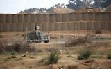 Illustrative: A IDF military vehicle drives near the border with Gaza east of Bureij, on December 6, 2019. (Hassan Jedi/Flash90)