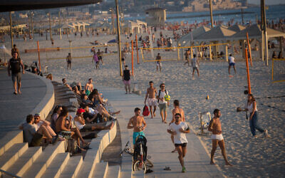 Illustrative: Israelis at the beach in Tel Aviv, on a hot summer day, July 6, 2021. (Miriam Alster/Flash90)
