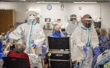 Illustrative: Medical staff working in in the coronavirus ward of the Herzog Medical Center in Jerusalem, on July 29, 2021. (Yonatan Sindel/Flash90)