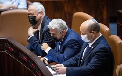 (From left to right) Defense Minister Benny Gantz, Foreign Minister Yair Lapid and Prime Minister Naftali Bennett at the Knesset in Jerusalem, on August 2, 2021. (Yonatan Sindel/Flash90)