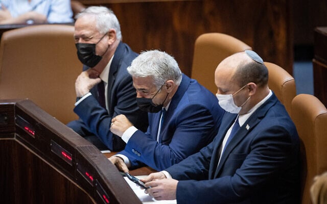 (From left to right) Defense Minister Benny Gantz, Foreign Minister Yair Lapid and Prime Minister Naftali Bennett at the Knesset in Jerusalem, on August 2, 2021. (Yonatan Sindel/Flash90) (From left to right) Defense Minister Benny Gantz, Foreign Minister Yair Lapid and Prime Minister Naftali Bennett at the Knesset in Jerusalem, on August 2, 2021. (Yonatan Sindel/Flash90)