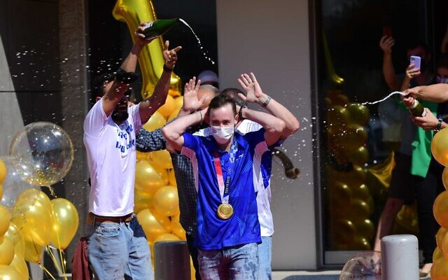 Artem Dolgopyat, who won a gold medal at the Olympic games in Tokyo, is greeted by family and friends during a welcome ceremony, at Ben-Gurion International Airport on August 3, 2021. (Tomer Neuberg/Flash90) Artem Dolgopyat, who won a gold medal at the Olympic games in Tokyo, is greeted by family and friends during a welcome ceremony, at Ben-Gurion International Airport on August 3, 2021. (Tomer Neuberg/Flash90)