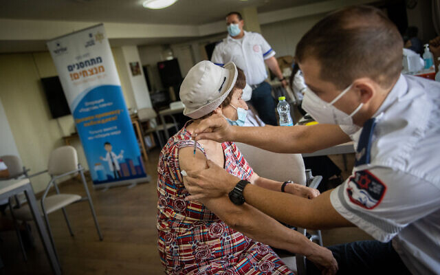 An elderly Israeli receives a third COVID-19 vaccine dose at a retirement residence in Jerusalem on August 4, 2021. (Yonatan Sindel/Flash90) An elderly Israeli receives a third COVID-19 vaccine dose at a retirement residence in Jerusalem on August 4, 2021. (Yonatan Sindel/Flash90)