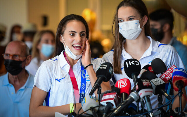 Olympic Gold medalist Linoy Ashram (L) and teammate Nicol Zelikman at Ben Gurion Airport, August 11, 2021. (Avshalom Sassoni/Flash90) Olympic Gold medalist Linoy Ashram (L) and teammate Nicol Zelikman at Ben Gurion Airport, August 11, 2021. (Avshalom Sassoni/Flash90)