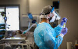 A health worker in the coronavirus ward at Ziv hospital in Safed on August 11, 2021. (David Cohen/Flash90)