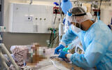 Hospital staff wearing safety gear as they work in the coronavirus ward of Ziv Medical Center in the northern city of Safed on August 11, 2021. (David Cohen/Flash90)
