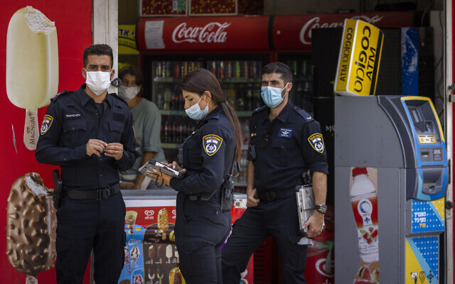 Police officers enforce COVID-19 emergency regulations in Jerusalem, August 11, 2021. (Olivier Fitoussi/Flash90) Police officers enforce COVID-19 emergency regulations in Jerusalem, August 11, 2021. (Olivier Fitoussi/Flash90)