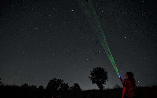 People watch the stars during a meteor shower in the skies above the Golan Heights, on August 13, 2021 (Michael Giladi/Flash90)