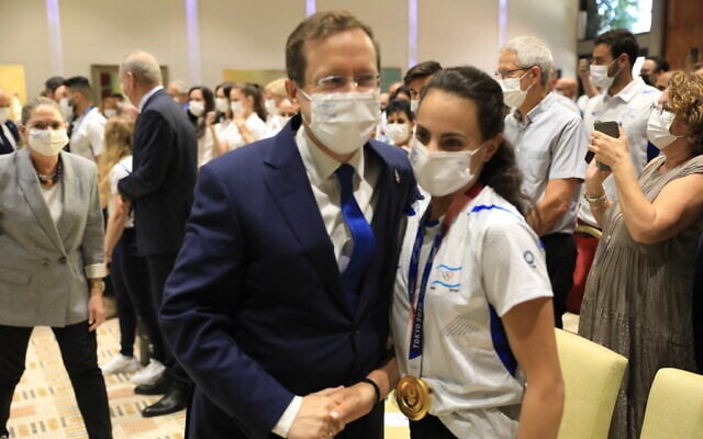 President Isaac Herzog meets Israeli gold medal-winning gymnast Linoy Ashram at the President's Residence in Jerusalem on August 16, 2021 (Olivier Fitoussi/Flash90)