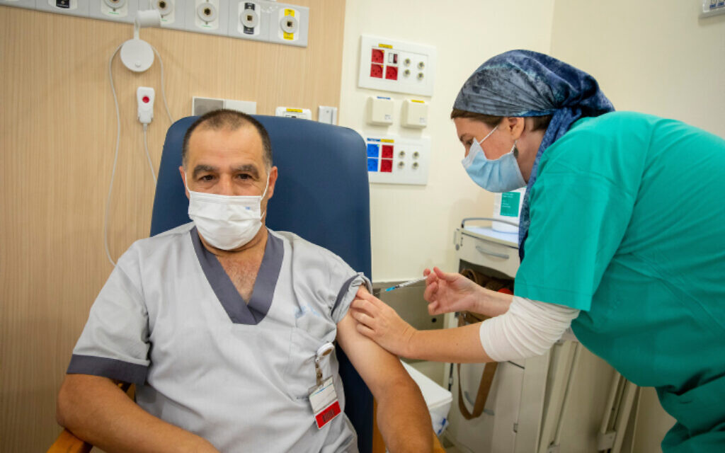 Medical staff receive their third dose of a COVID-19 vaccine in Jerusalem on August 17, 2021 (Olivier Fitoussi/Flash90) Medical staff receive their third dose of a COVID-19 vaccine in Jerusalem on August 17, 2021 (Olivier Fitoussi/Flash90)