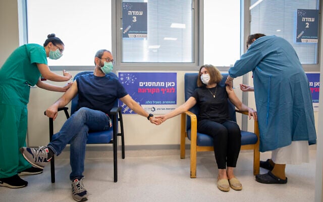 A couple receive their third dose of the COVID-19 vaccine at Shaare Zedek hospital, on August 17, 2021, in Jerusalem. (Olivier Fitoussi/Flash90) A couple receive their third dose of the COVID-19 vaccine at Shaare Zedek hospital, on August 17, 2021, in Jerusalem. (Olivier Fitoussi/Flash90)