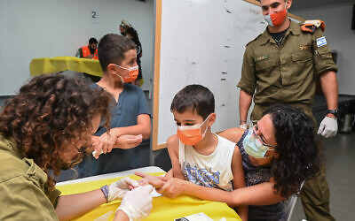 IDF officers and soldiers conduct serological testing in Katzrin, August 22, 2021. (Michael Giladi/Flash90)