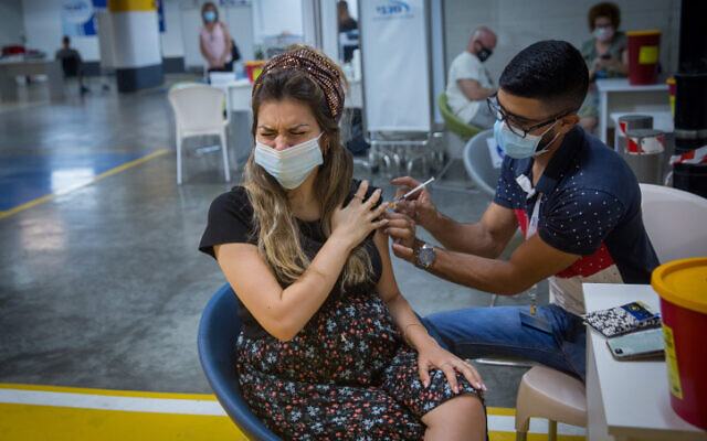 Illustrative: A pregnant woman receives a COVID-19 vaccine, at a Maccabi Health vaccination center at the Givatayim mall, outside of Tel Aviv, August 23, 2021. (Miriam Alster/Flash90) Illustrative: A pregnant woman receives a COVID-19 vaccine, at a Maccabi Health vaccination center at the Givatayim mall, outside of Tel Aviv, August 23, 2021. (Miriam Alster/Flash90)