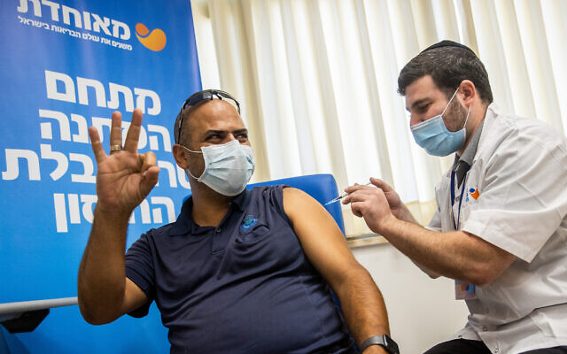 A man in his 30s receives a third COVID-19 vaccine dose, at a vaccination center in Jerusalem, on August 24, 2021. (Yonatan Sindel/Flash90) A man in his 30s receives a third COVID-19 vaccine dose, at a vaccination center in Jerusalem, on August 24, 2021. (Yonatan Sindel/Flash90)