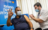 A man receives a coronavirus vaccine booster at a Meuhedet vaccination center in Jerusalem, on August 24, 2021. (Yonatan Sindel/Flash90)