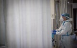 Hadassah Ein Kerem team members wearing safety gear as they work in the coronavirus ward of the Hadassah Ein Kerem medical center in Jerusalem on August 25, 2021. (Yonatan Sindel/Flash90)