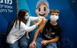 13-year-old Tomer Zarfati receives his second dose of the COVID-19 vaccine at a temporary Clalit health care center in Jerusalem, August 29, 2021. (Yonatan Sindel/Flash90)