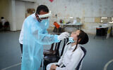 Health personnel take test samples on Israelis wanting to travel abroad, at a COVID-19 testing station in Safed, on August 31, 2021. (David Cohen/Flash90)